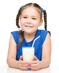 Image showing Cute little girl with a glass of milk