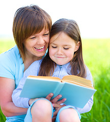 Image showing Mother is reading book with her daughter