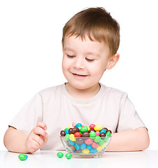 Image showing Portrait of a boy with candies