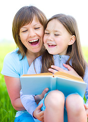 Image showing Mother is reading book with her daughter