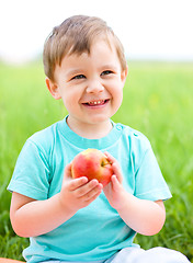 Image showing Portrait of a happy little boy with apple