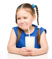 Image showing Sad little girl with a glass of milk