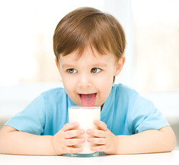 Image showing Cute little boy with a glass of milk