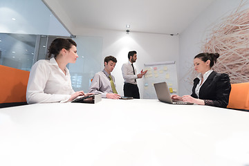 Image showing business people group brainstorming and taking notes to flip boa