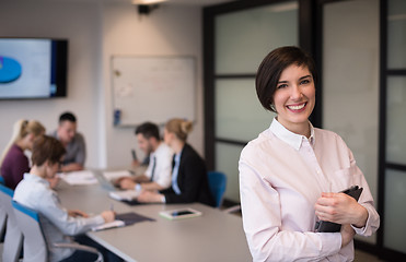 Image showing hispanic businesswoman with tablet at meeting room