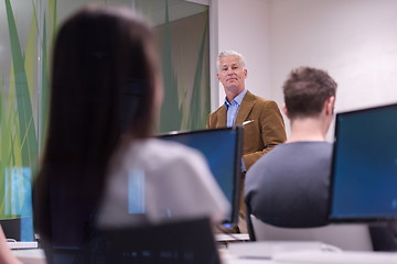 Image showing teacher and students in computer lab classroom