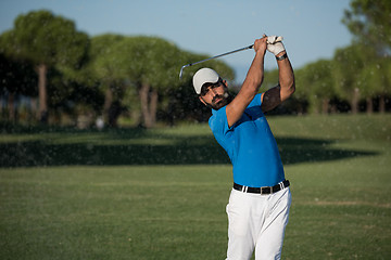 Image showing pro golfer hitting a sand bunker shot