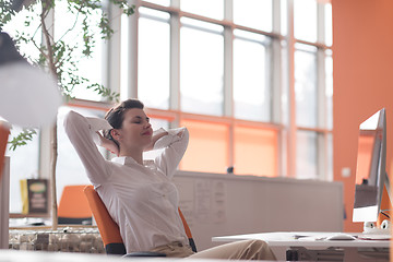 Image showing happy young business woman relaxing and geting insiration