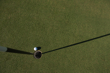 Image showing top view of golf ball in the hole