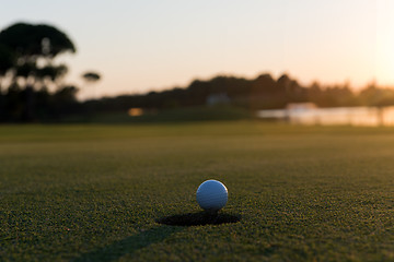 Image showing golf ball on edge of  the hole