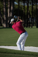 Image showing golfer hitting a sand bunker shot