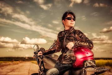 Image showing Biker girl sitting on motorcycle