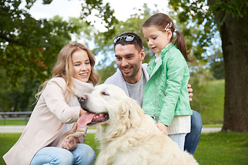 Image showing happy family with labrador retriever dog in park