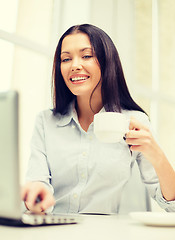 Image showing smiling businesswoman or student with laptop