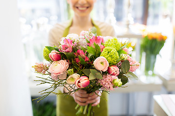 Image showing close up of woman holding bunch at flower shop