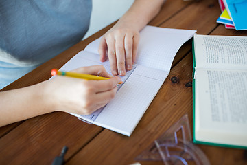 Image showing close up of hands with ruler and pencil drawing 