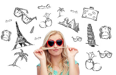 Image showing happy young woman making mustache with her hair