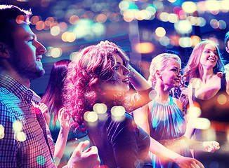 Image showing smiling friends dancing in club