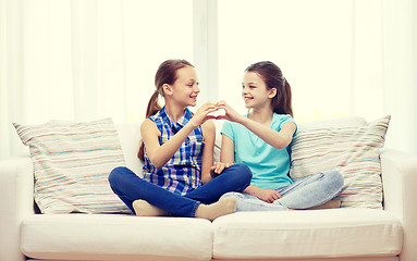 Image showing happy little girls showing heart shape hand sign