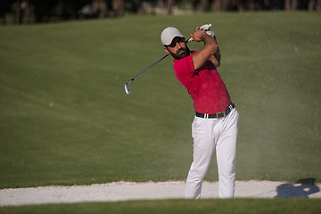 Image showing golfer hitting a sand bunker shot