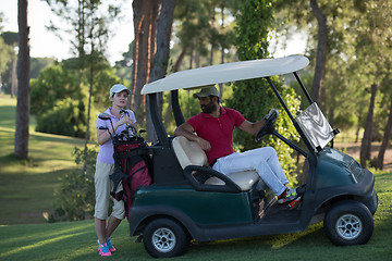 Image showing couple in buggy on golf course