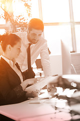 Image showing business couple working together on project, sunrise in backgrou