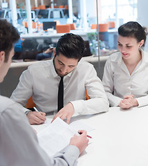 Image showing young couple signing contract documents on partners back