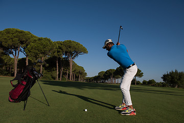 Image showing golf player hitting shot