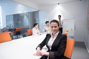 Image showing young business woman on meeting  using laptop computer