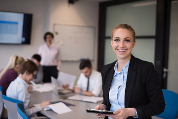 Image showing business woman working on tablet at meeting room