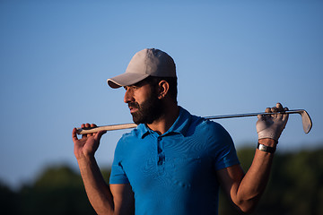 Image showing golfer  portrait at golf course on sunset