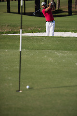 Image showing golfer hitting a sand bunker shot