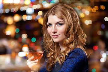 Image showing glamorous woman with cocktail at night club or bar