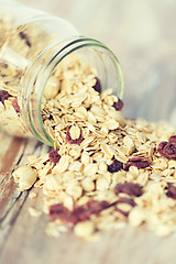 Image showing close up of jar with granola or muesli on table