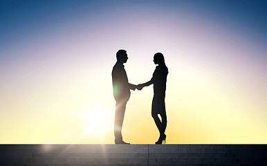 Image showing business partners silhouettes shaking hands