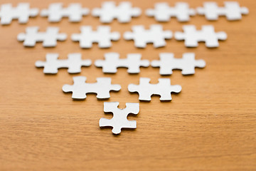 Image showing close up of puzzle pieces on wooden surface