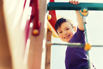 Image showing happy little boy climbing on children playground