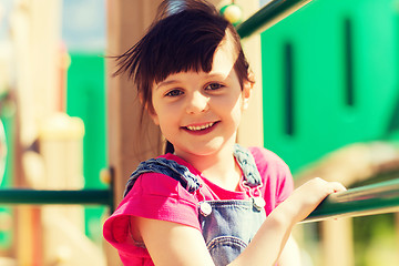 Image showing happy little girl climbing on children playground