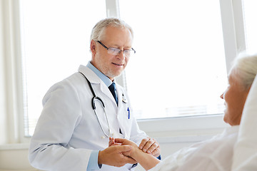 Image showing doctor checking senior woman pulse at hospital