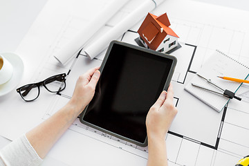 Image showing close up of hand with blueprint and tablet pc