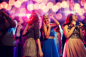 Image showing smiling friends dancing in club