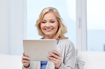 Image showing happy middle aged woman with tablet pc at home