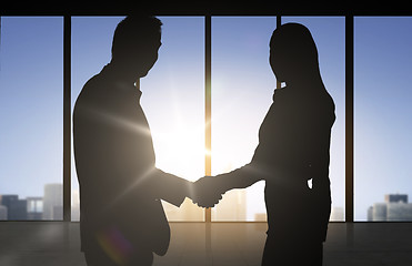 Image showing business partners silhouettes shaking hands