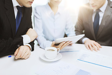 Image showing business team with graph, tablet pc and coffee