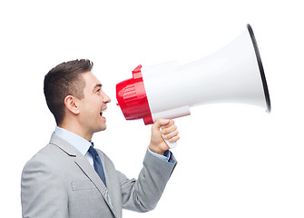 Image showing happy businessman in suit speaking to megaphone