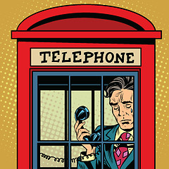 Image showing Retro man crying in a phone booth