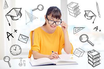 Image showing happy asian young woman student learning at home