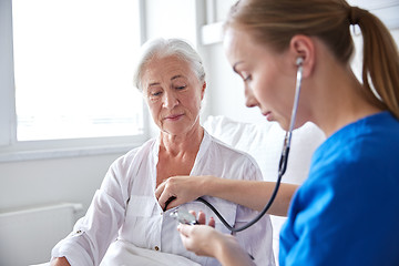 Image showing nurse with stethoscope and senior woman at clinic