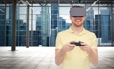 Image showing happy man in virtual reality headset with gamepad