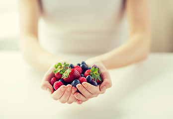 Image showing close up of woman hands holding berries